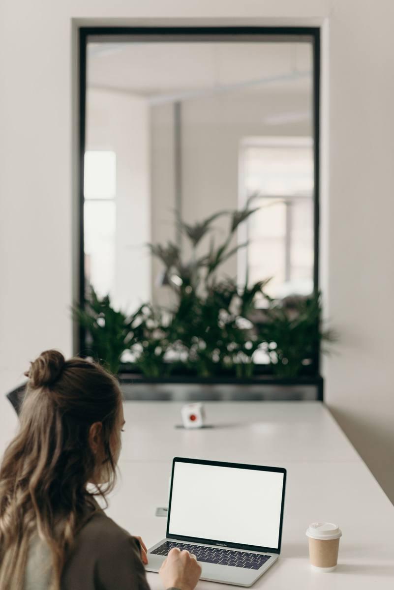 Person working on a laptop in a modern home office