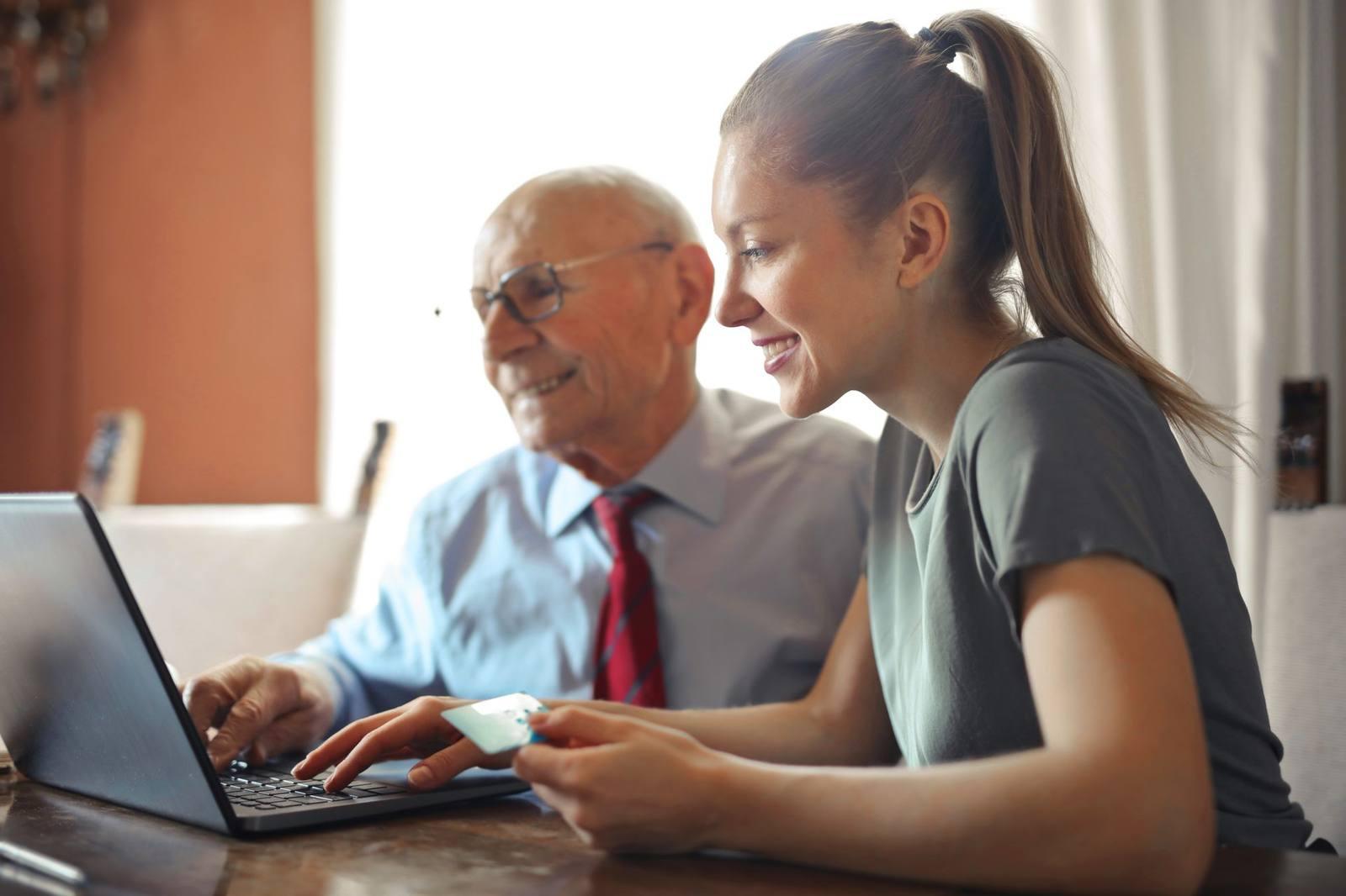 A technician helping a homeowner with a laptop