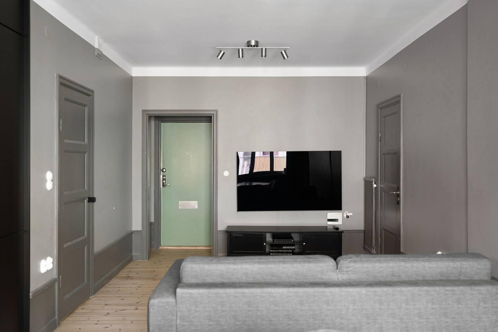 A flat-screen TV mounted on a living room wall