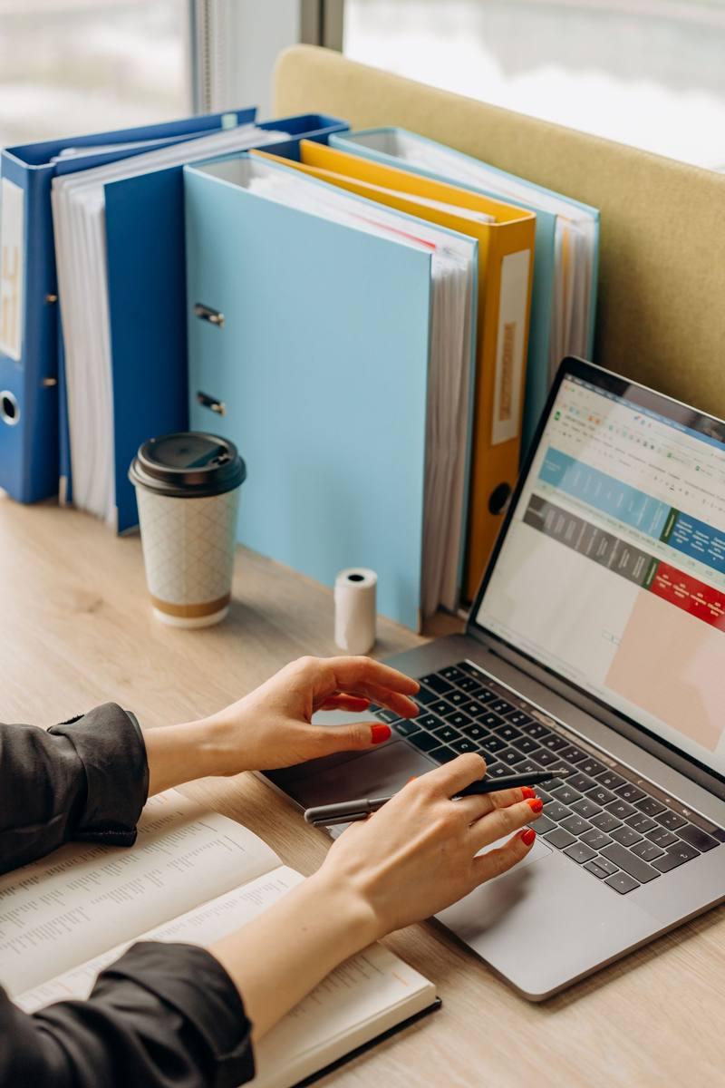 Close-up of hands typing on a laptop keyboard